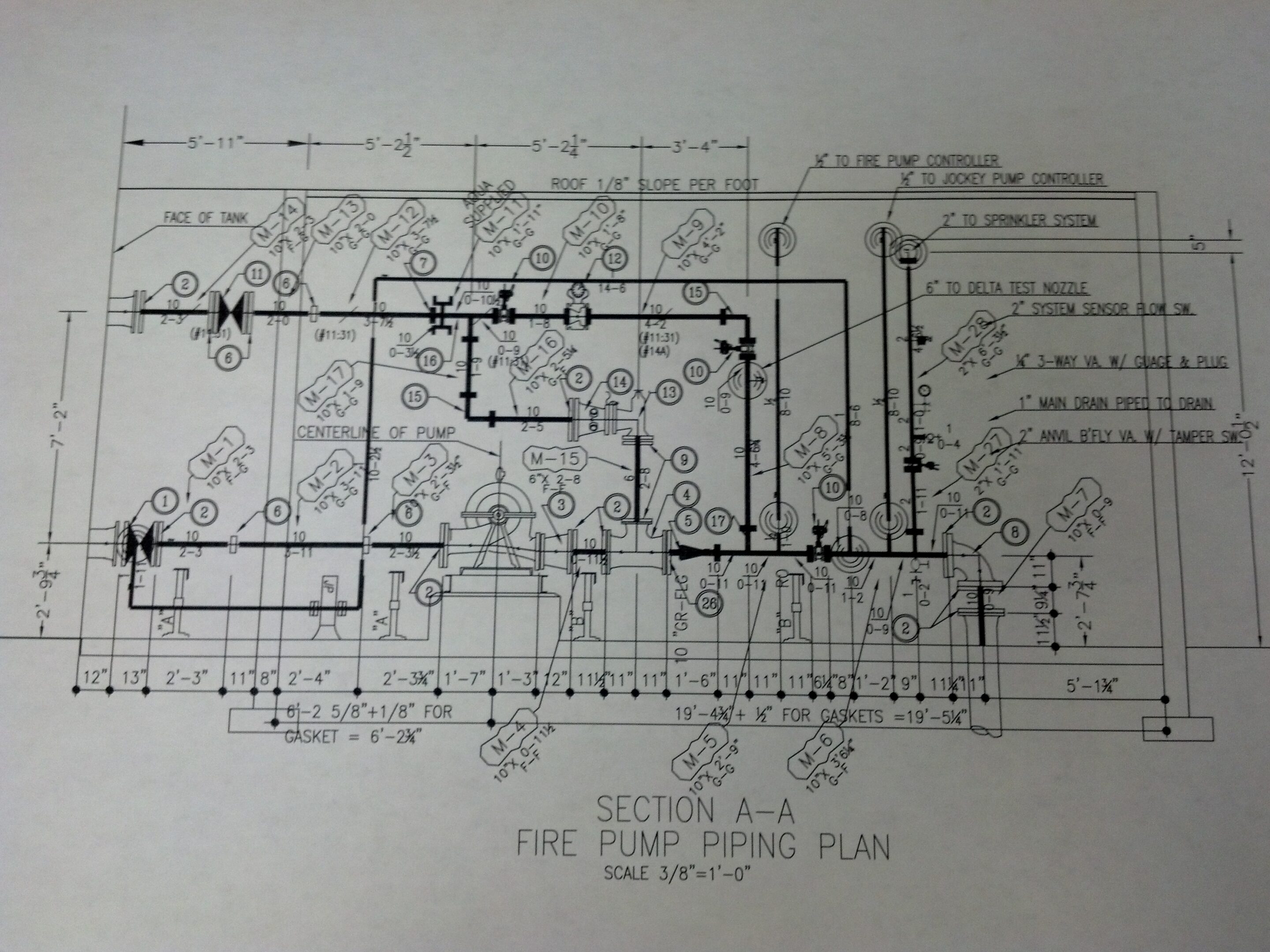 Black and white architectural floor plan with detailed piping layout.